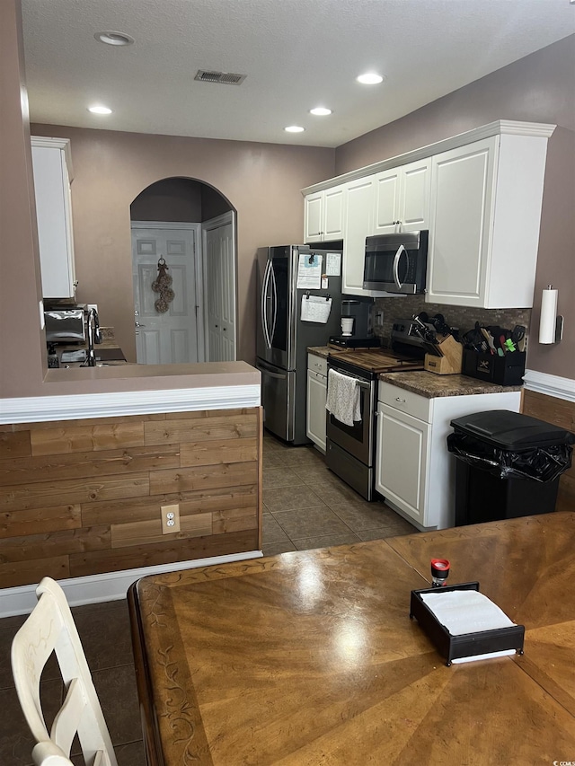 389 Cabo Loop, Myrtle Beach, SC 29588 - kitchen with appliances with stainless steel finishes, white cabinetry, tasteful backsplash, recessed lighting, and tile patterned flooring