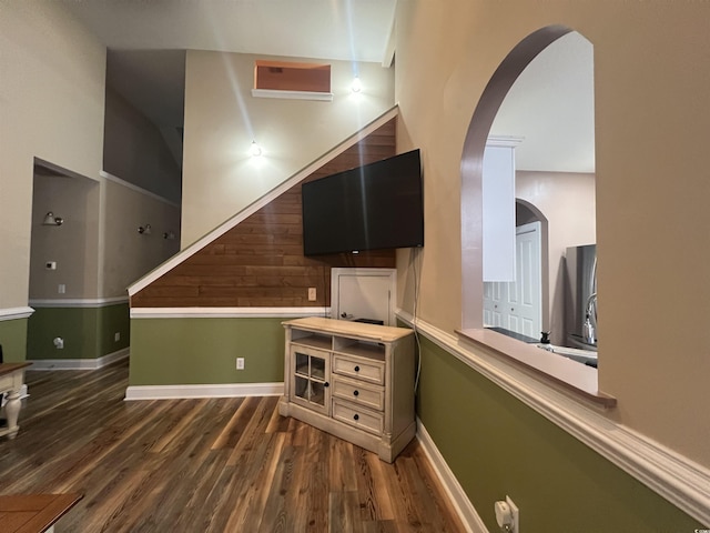 389 Cabo Loop, Myrtle Beach, SC 29588 - unfurnished living room with arched walkways, wood finished floors, and baseboards