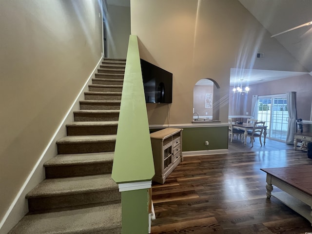 389 Cabo Loop, Myrtle Beach, SC 29588 - staircase with high vaulted ceiling, wood finished floors, a chandelier, arched walkways, and baseboards
