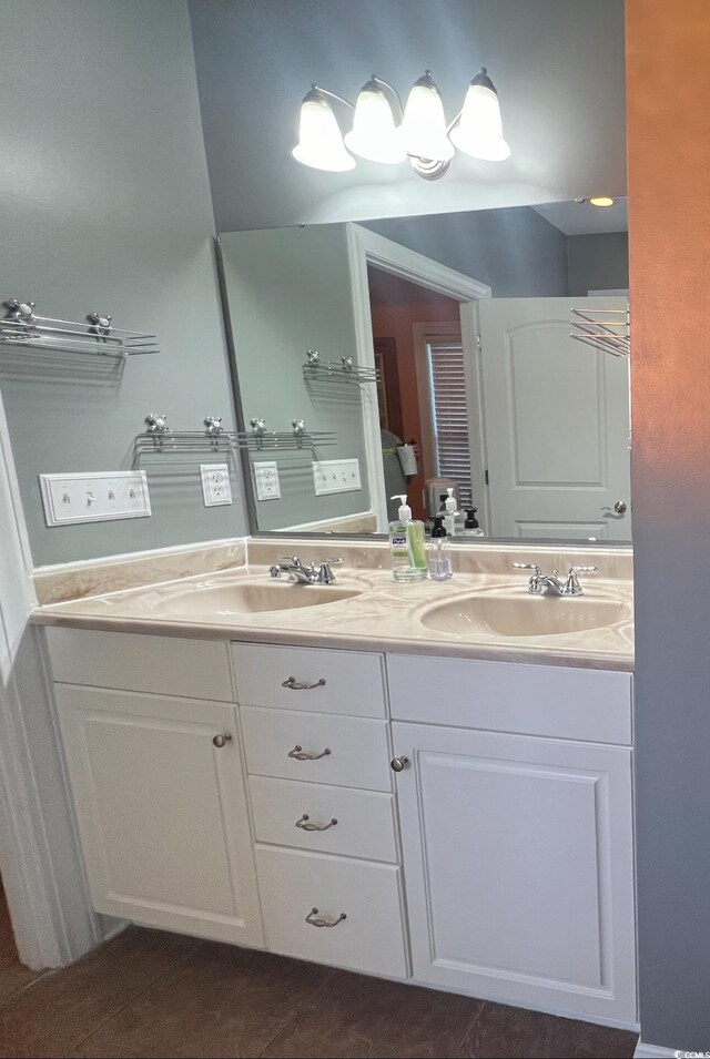 bathroom with toilet, vanity, and tile patterned floors