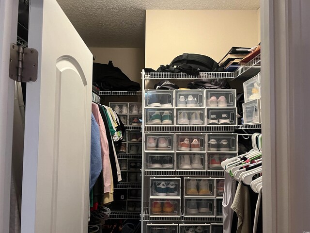 unfurnished bedroom featuring ornamental molding, a closet, and dark colored carpet