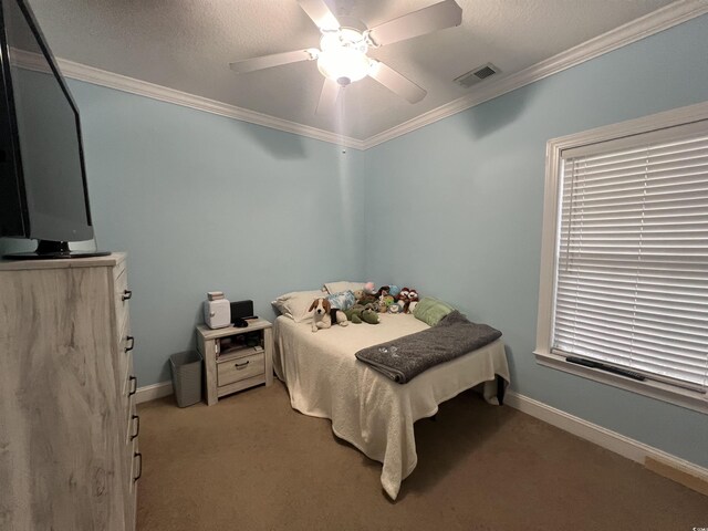 bedroom with ceiling fan, ornamental molding, a closet, and carpet floors