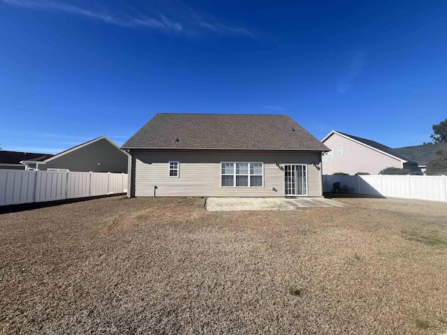 rear view of property with a patio area and a yard