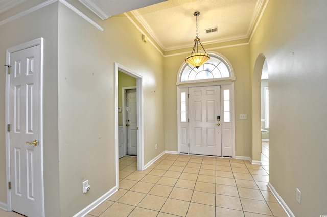 tiled foyer entrance featuring ornamental molding