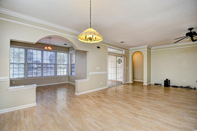 spare room with ceiling fan with notable chandelier, a textured ceiling, and light wood-type flooring