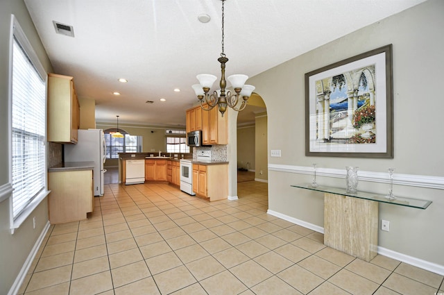 kitchen featuring white appliances, hanging light fixtures, tasteful backsplash, light tile patterned flooring, and sink