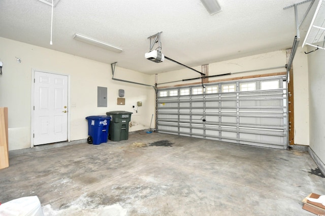 garage featuring electric panel and a garage door opener