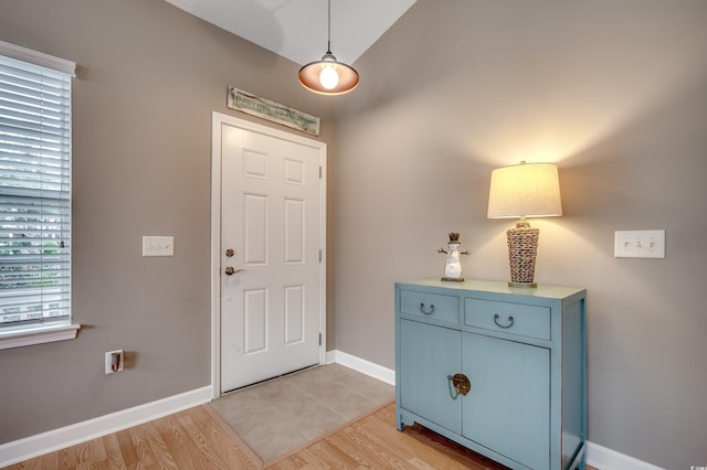 foyer entrance featuring light hardwood / wood-style flooring and vaulted ceiling