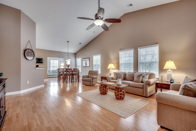 living room featuring ceiling fan, light hardwood / wood-style flooring, and high vaulted ceiling