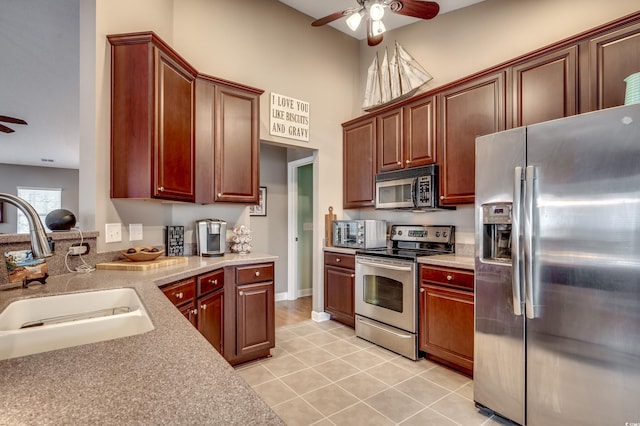 kitchen featuring sink, ceiling fan, light tile patterned floors, and appliances with stainless steel finishes