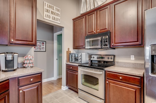 kitchen featuring appliances with stainless steel finishes and light tile patterned flooring