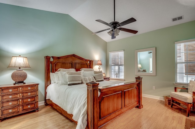 bedroom with ceiling fan, multiple windows, light wood-type flooring, and lofted ceiling