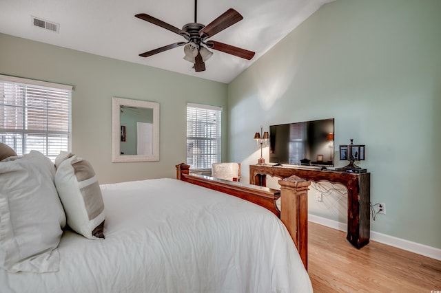 bedroom with lofted ceiling, ceiling fan, and light hardwood / wood-style flooring