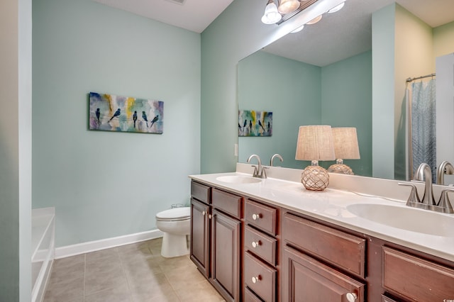 bathroom featuring a tub to relax in, tile patterned floors, vanity, and toilet