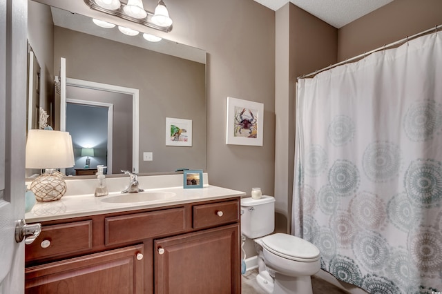 bathroom with toilet and vanity