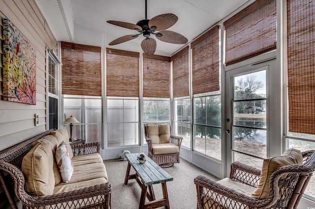 sunroom / solarium with ceiling fan and vaulted ceiling