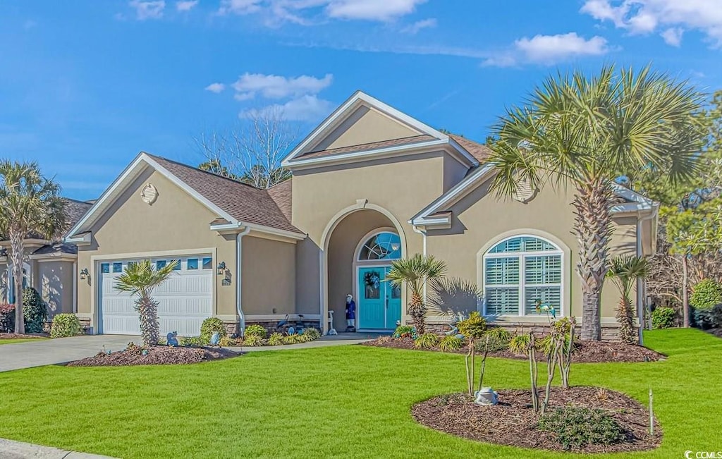 view of front of home featuring a garage and a front lawn