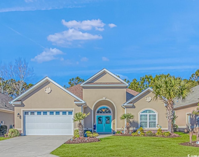 view of front facade with a front lawn, a garage, and french doors