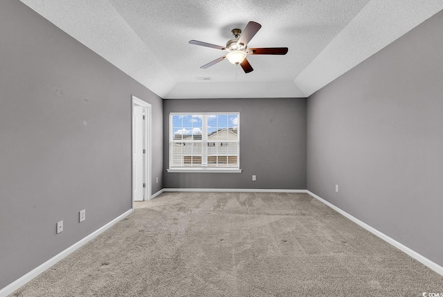 unfurnished room with a textured ceiling, ceiling fan, light carpet, and lofted ceiling