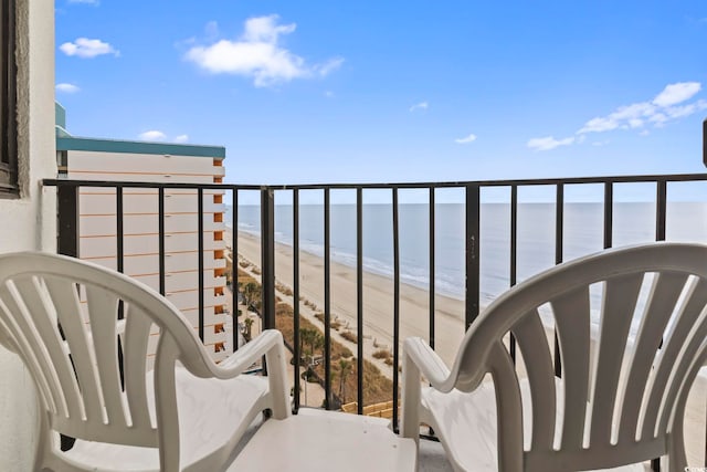 balcony featuring a water view and a view of the beach