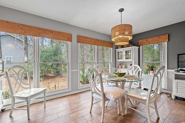 dining space featuring a textured ceiling and a chandelier