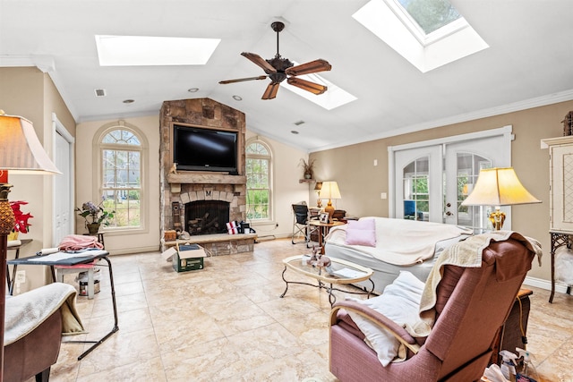 living room with vaulted ceiling, crown molding, french doors, and a fireplace