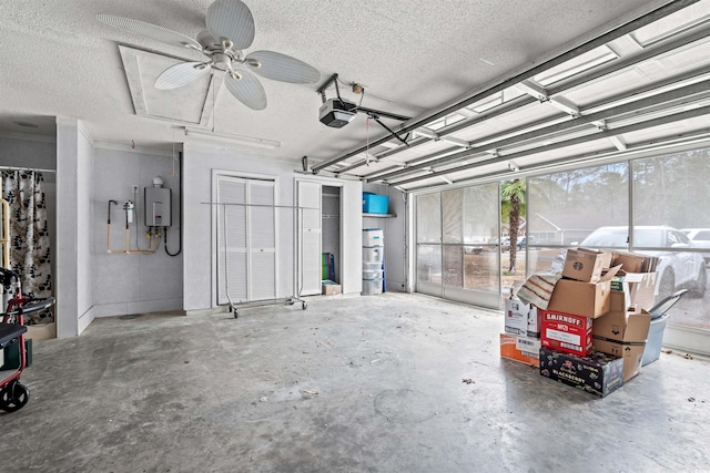 garage featuring tankless water heater and a garage door opener