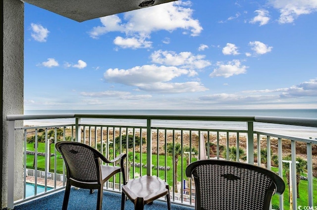 balcony with a water view and a beach view