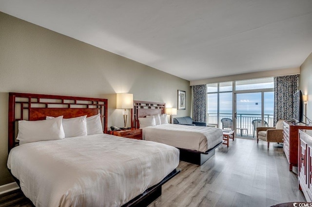 bedroom featuring wood finished floors and access to exterior