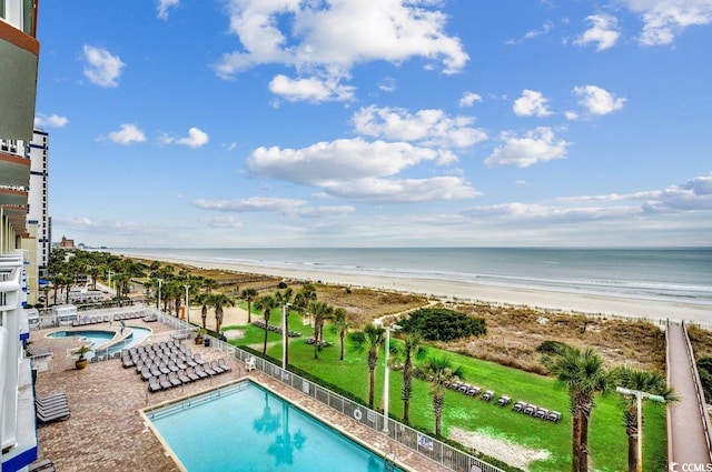 pool with a water view and a view of the beach