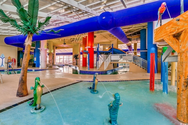 view of playground featuring a patio and a community pool