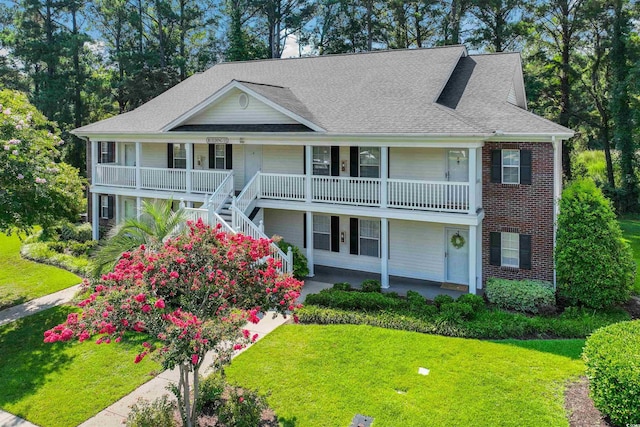 view of front of home featuring a front yard and a porch