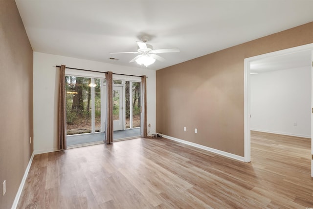 empty room featuring ceiling fan and light hardwood / wood-style floors