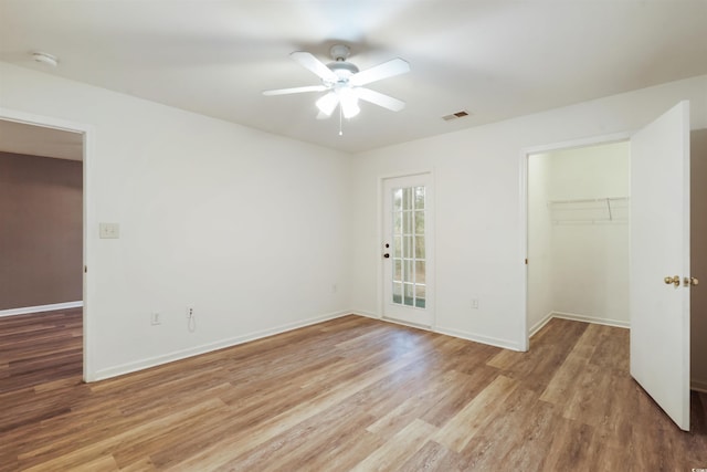 spare room featuring ceiling fan and light wood-type flooring