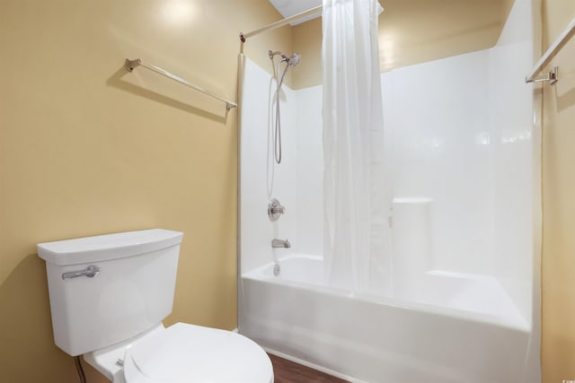 bathroom featuring toilet and shower / bathtub combination with curtain