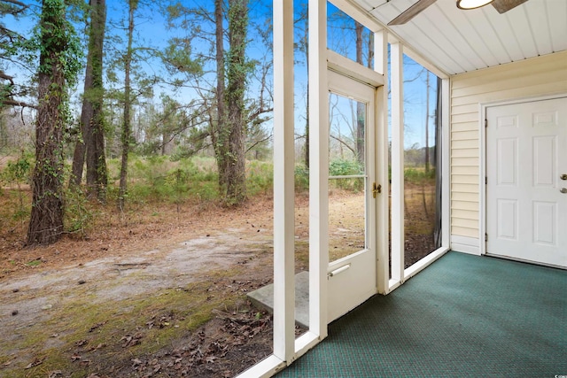 unfurnished sunroom with ceiling fan and a healthy amount of sunlight