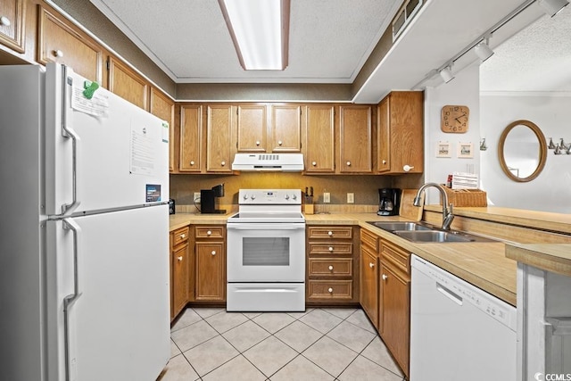 kitchen with sink, a textured ceiling, white appliances, light tile patterned floors, and rail lighting