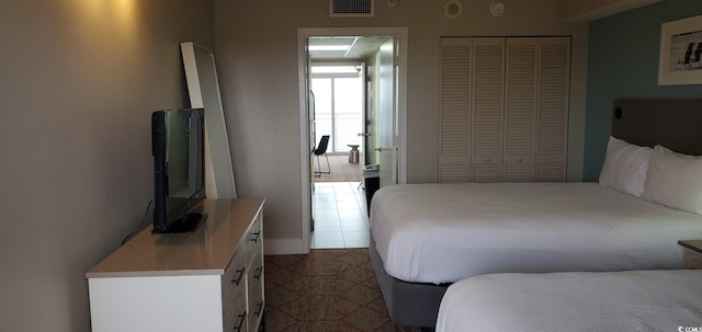 tiled bedroom featuring a closet