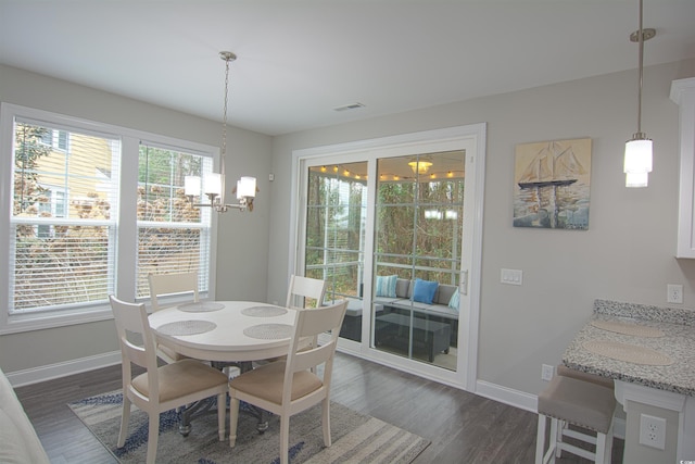 dining area with a notable chandelier and dark wood-type flooring