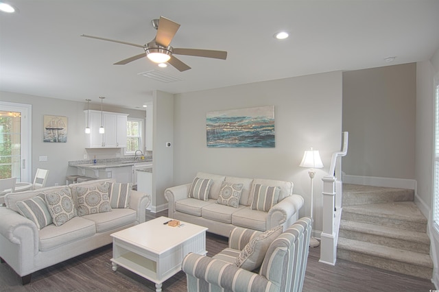 living room featuring ceiling fan, dark hardwood / wood-style flooring, and sink