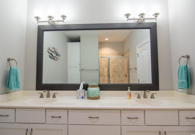 bathroom with walk in shower and vanity