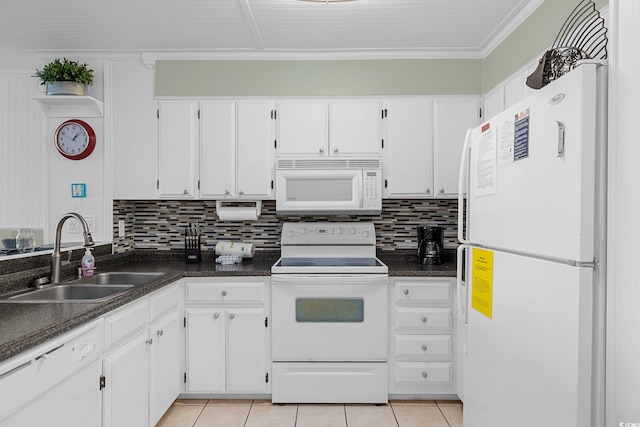 kitchen featuring white appliances, white cabinetry, light tile patterned floors, and sink