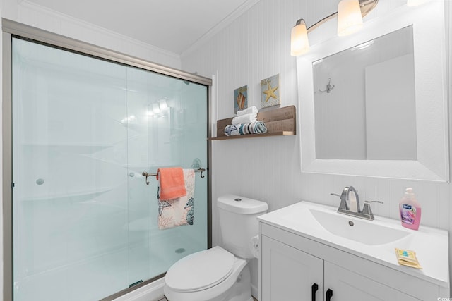 bathroom with toilet, an enclosed shower, ornamental molding, and vanity