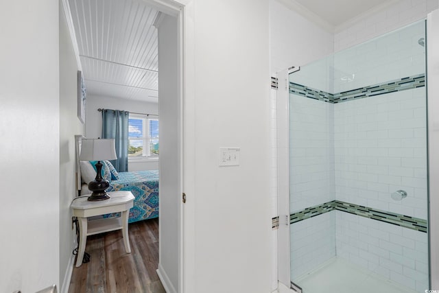 bathroom with an enclosed shower and wood-type flooring