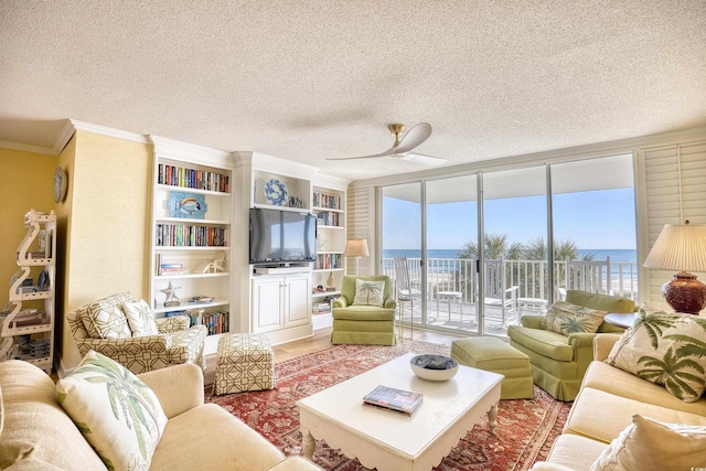 living room featuring a wall of windows, a textured ceiling, ceiling fan, and crown molding