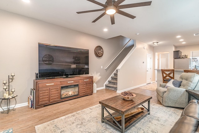 living room with hardwood / wood-style floors and ceiling fan