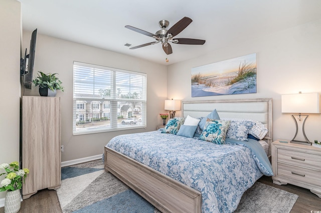 bedroom with ceiling fan and dark hardwood / wood-style floors