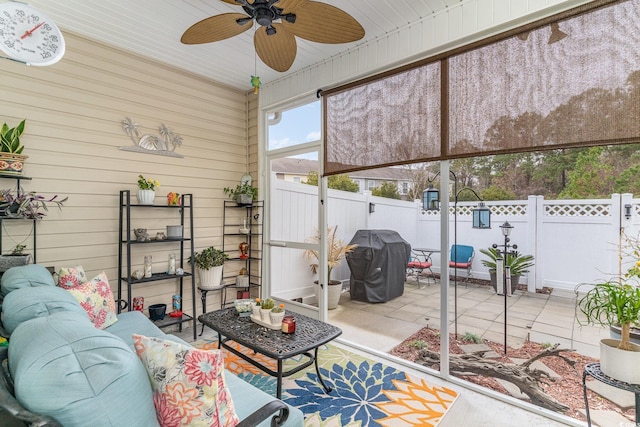 sunroom featuring ceiling fan