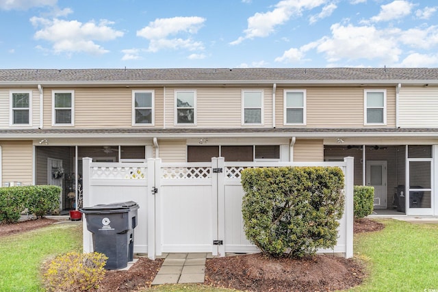 multi unit property with a front lawn and a sunroom