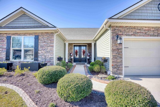 craftsman house featuring french doors, a garage, and a front lawn